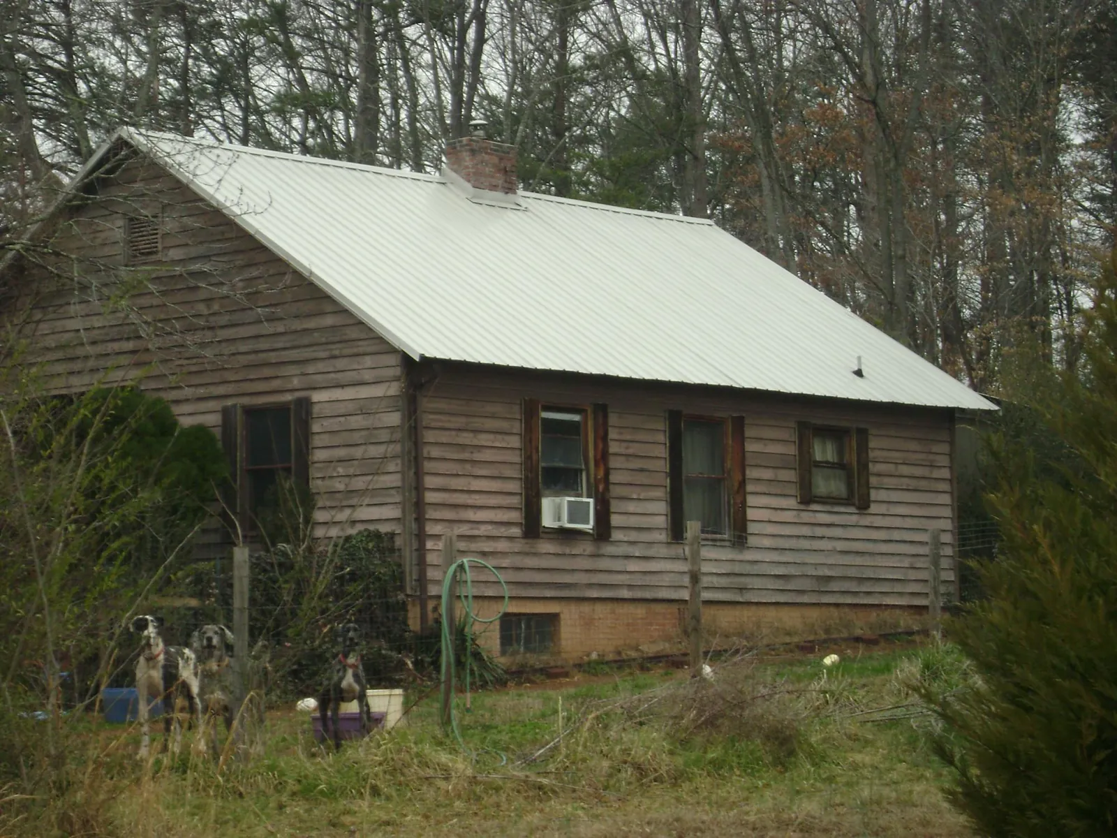 White metal roof on an old wood sided farmhouse, from a Metal Roof Installation job in Fonda
